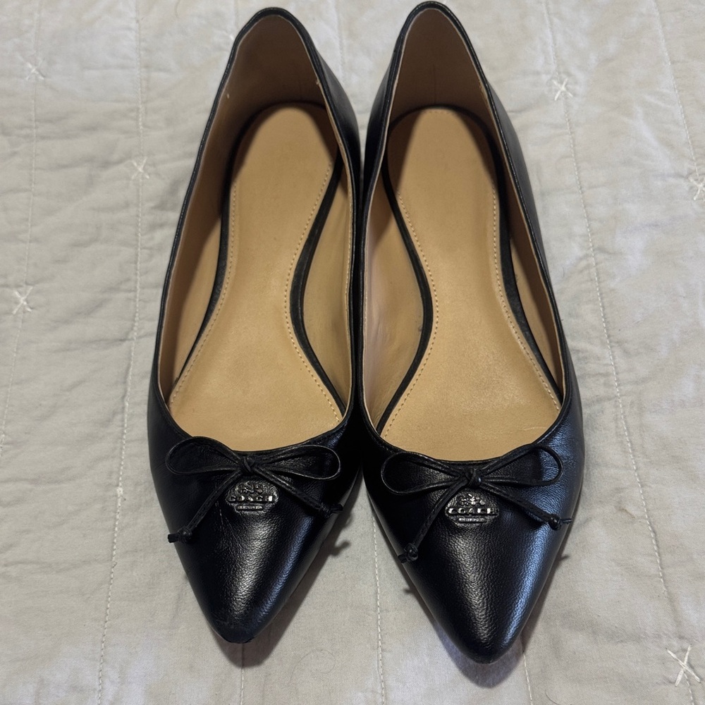 Coach Black Women's  flats. Is a little peeling at the tip in the right shoe.